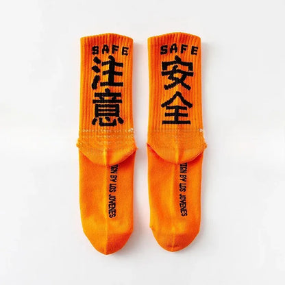 Bright orange crew tactical socks streetwear with bold black safe text and ribbed quality cotton harajuku casual skateboard sock