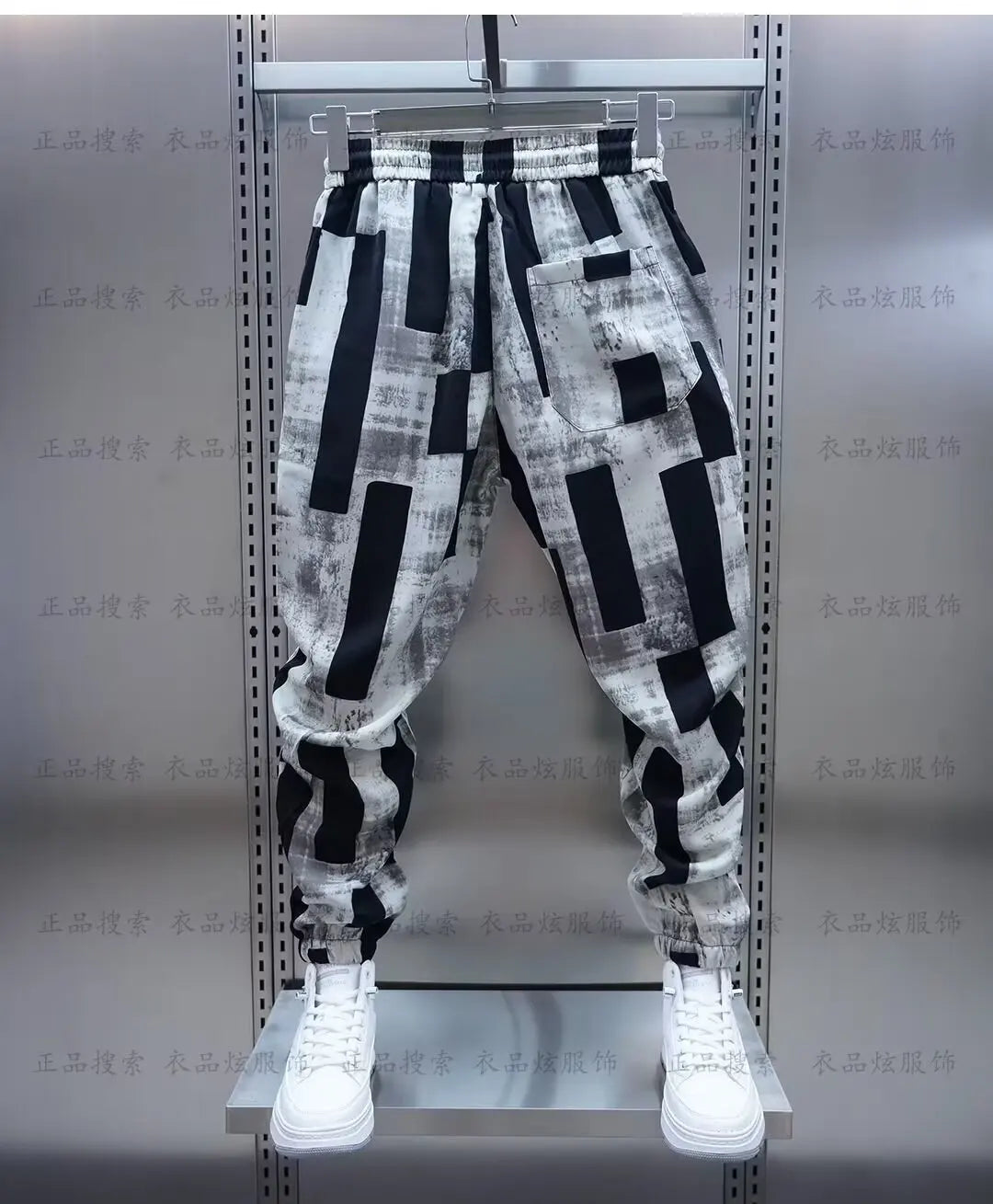 Black and white geometric-patterned jogging sweatpant luxury with relaxed fit elastic waistband cuffed hems men clothing streetwear