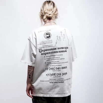 White cotton hip hop streetwear t shirt with black graphic print y2k text and circular emblem in russian church aid theme