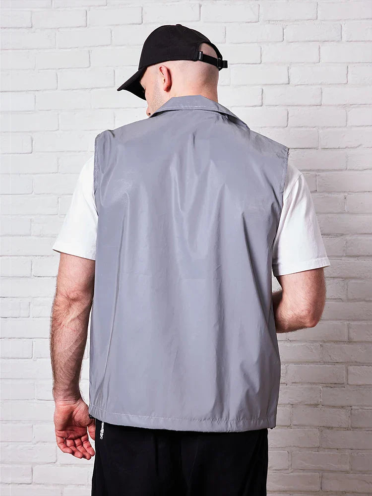 Gray streetwear reflective sleeveless vest with subtle sheen and structured back panel for night running dancing outdoors