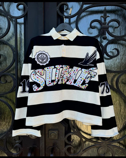 Black and white striped rugby-style polo shirt with cream collar and colorful sequined sumé lettering for america harajuku fashion polo shirts y2k