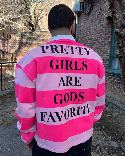 Back of a vibrant pink and white striped rugby-style polo shirt with black fashion letter print in america harajuku fashion