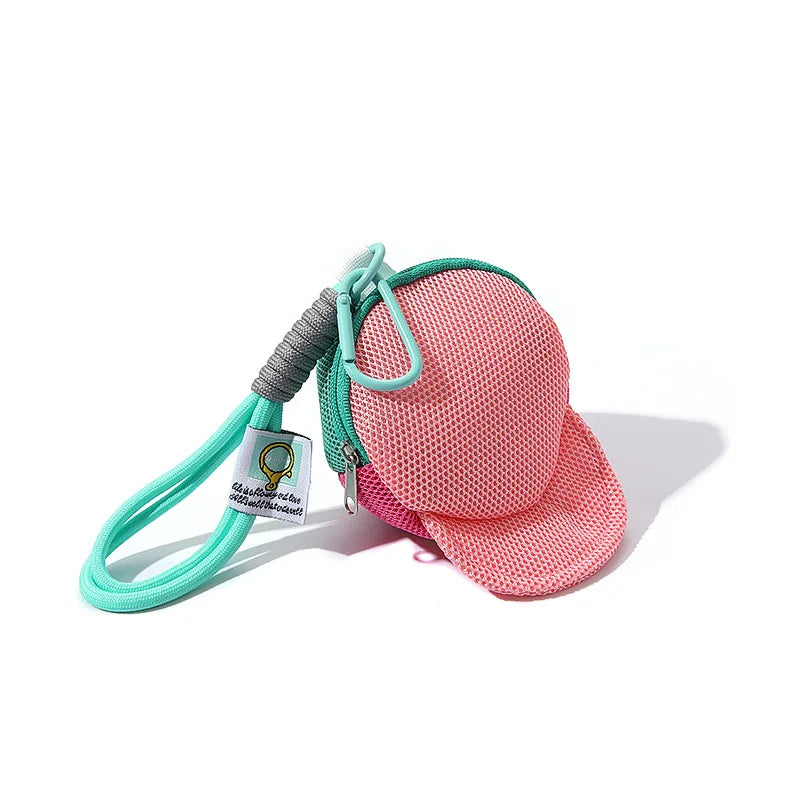 Pink mesh cap-shaped pouch with teal zipper carabiner clip and matching lanyard for keys earphones and coins