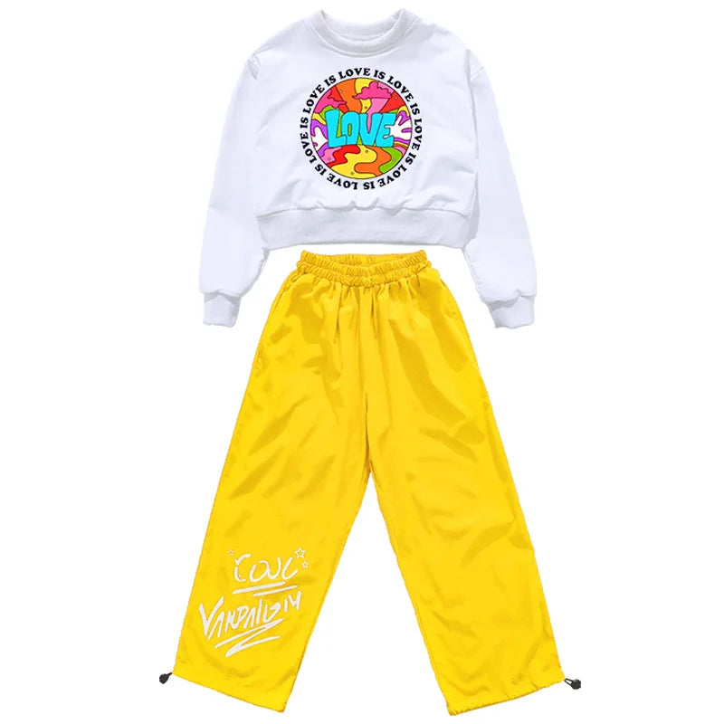 White cropped sweatshirt with colorful love graphic and yellow satin pants with white graffiti lettering hip hop clothing set