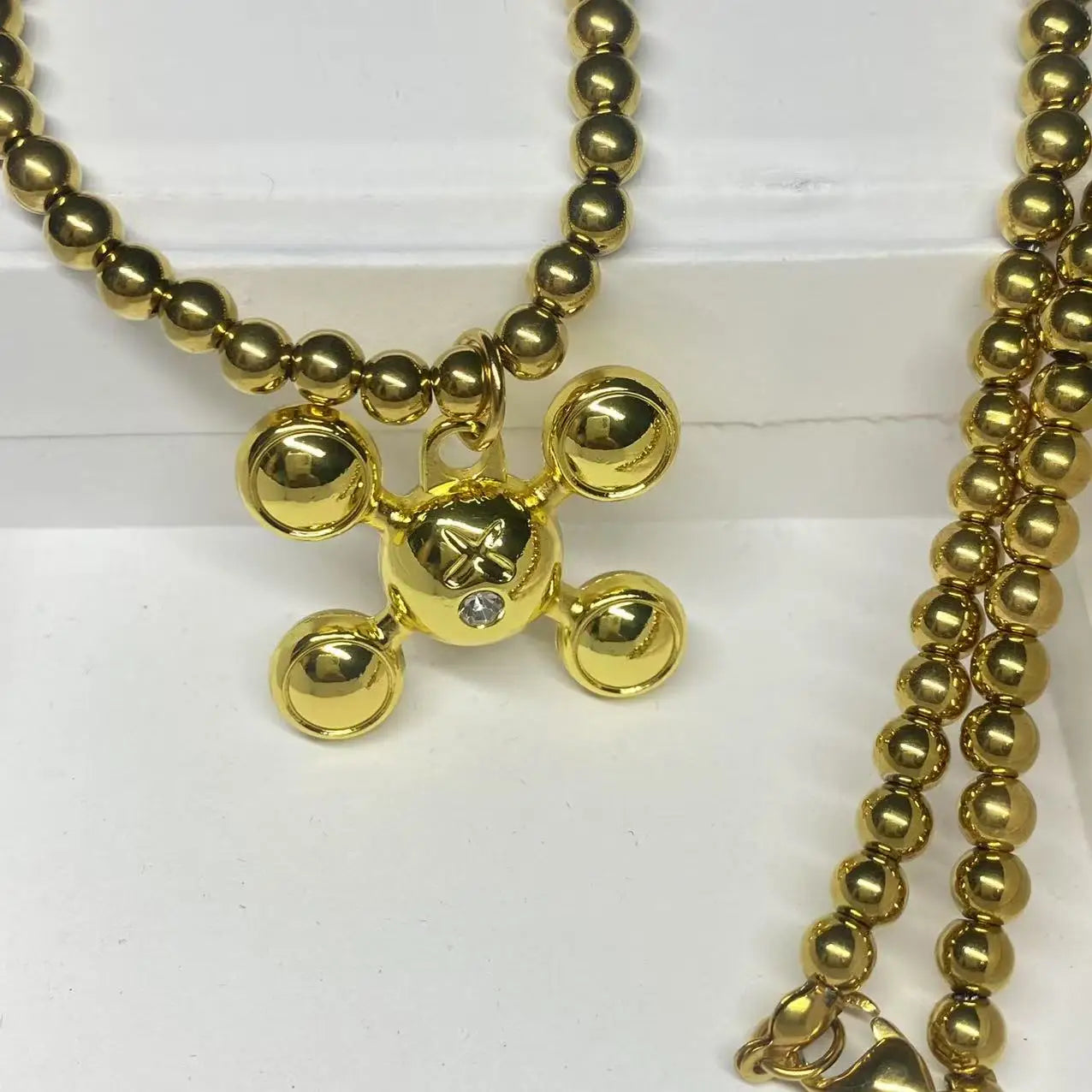 Gold-colored mickey mouse pendant with central diamond accent on hip-hop style stainless steel bead chain rapper necklace