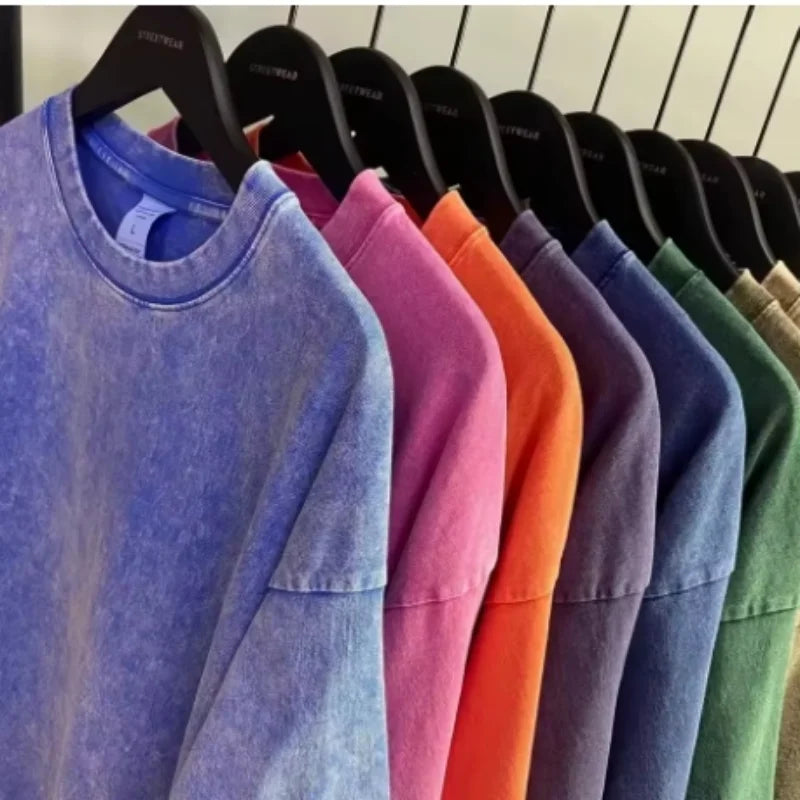A row of faded cotton crewneck sweatshirts in assorted harajuku multicolors oversized style for unisex summer retro wear