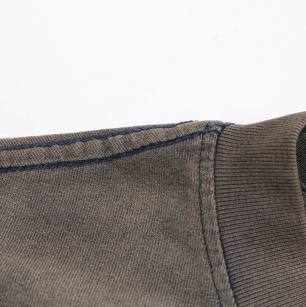 A close-up of a dark olive green ribbed knit sleeve with navy blue stitching on a hip hop shirt harajuku cotton tee