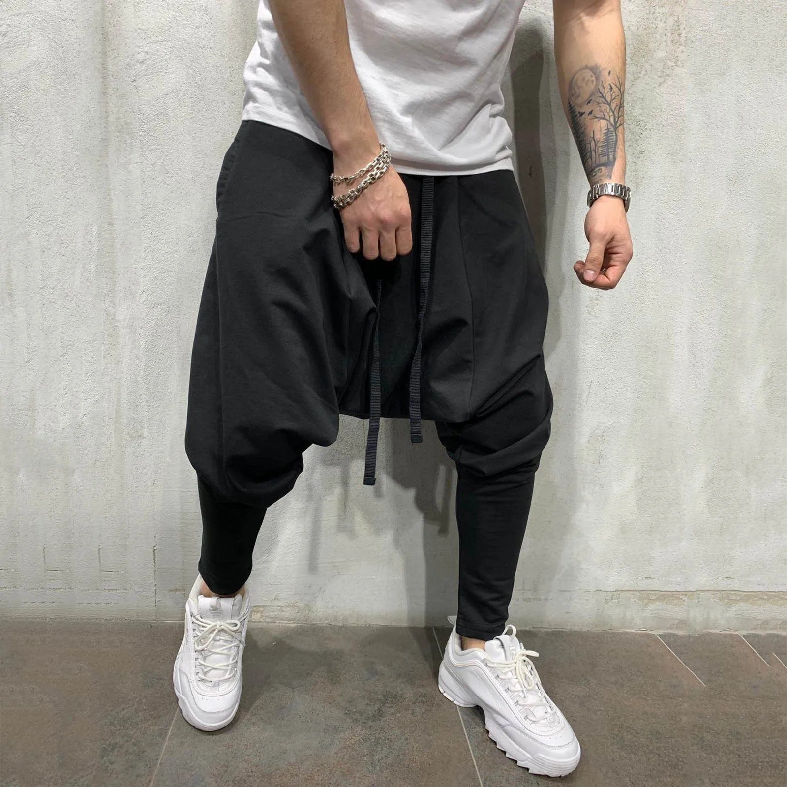 Black hip hop trend loose solid jogger pants with drawstring waist and tapered legs for street sportswear