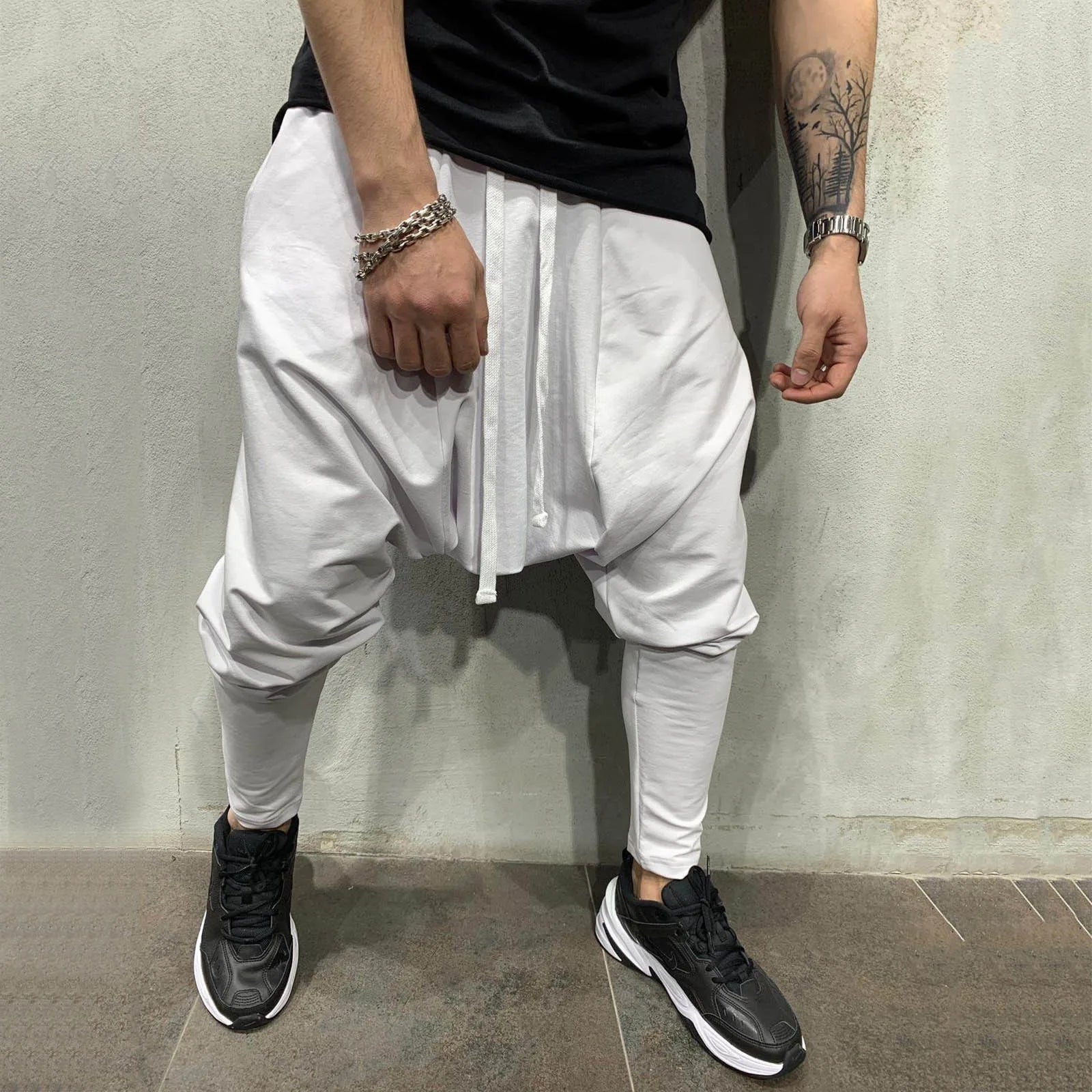 White loose-fitting jogger pants with drawstring waist and tapered legs in hip hop trend loose solid style