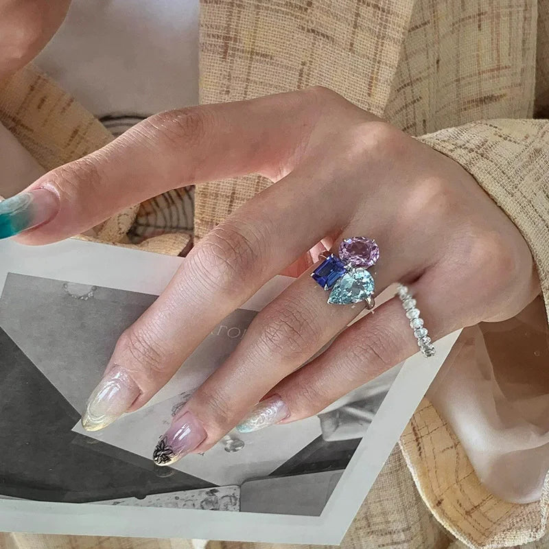 A hip hop unique multi-stone ring for women punk fashion with pink, blue zircon stones on a silver band