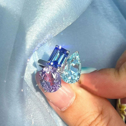 A hip hop unique silver-toned adjustable ring for women punk fashion featuring three bling zircon gemstones in blue and purple