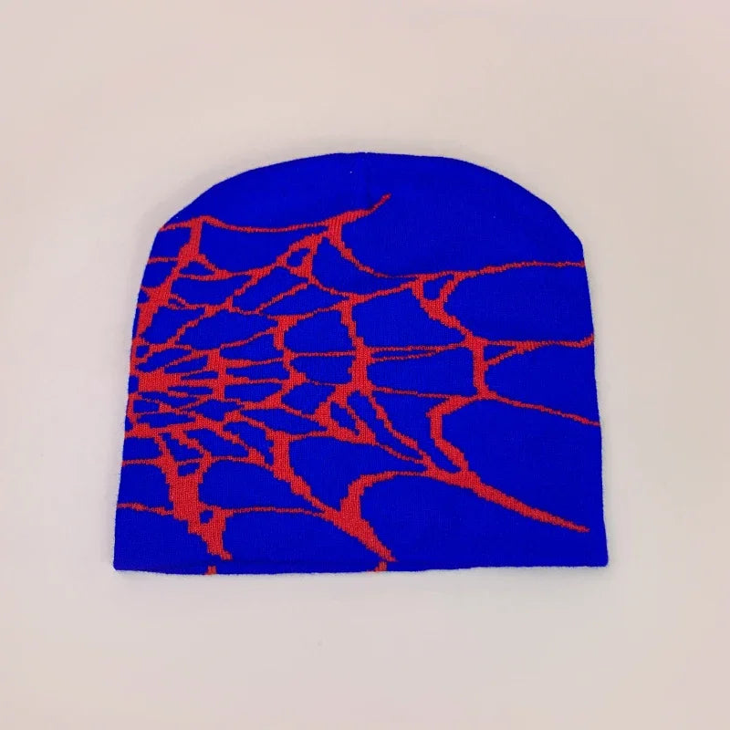 A vibrant blue wool knit beanie with a bold red spiderweb pattern for hip hop and retro autumn winter fashion