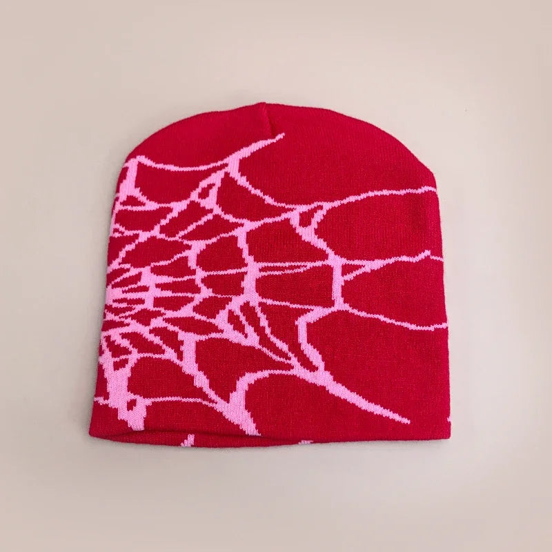 A vibrant red wool hip hop beanie with a bold pink spiderweb knit pattern for autumn and winter fashion