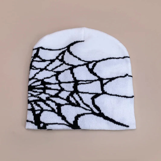 White wool knit beanie with a bold black spiderweb pattern designed for hip hop gothic retro street fashion