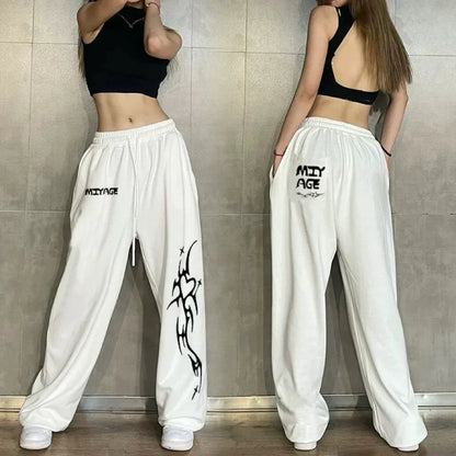 Back view of white cotton hip hop women casual dance sweatpants with black tribal graphic spring autumn streetwear design