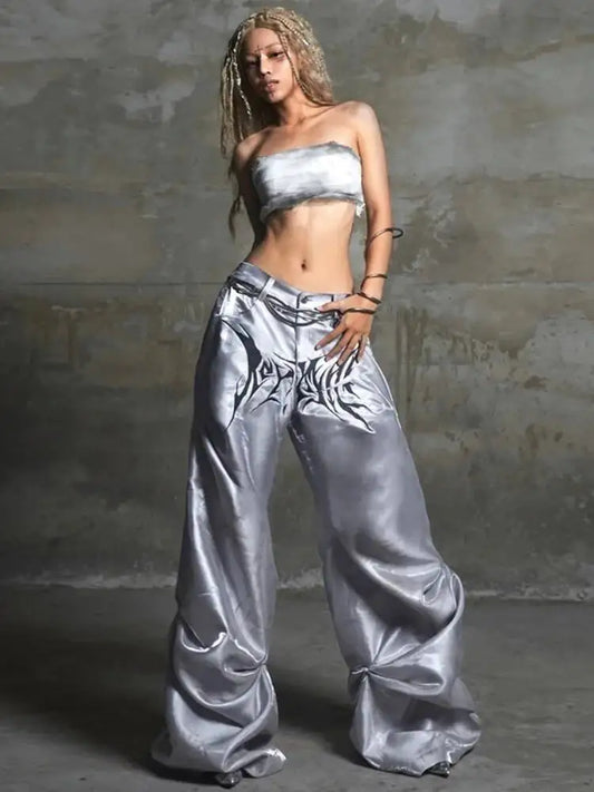 Silver satin high waist wide leg pants with bold black tribal embroidery in hip hop street style