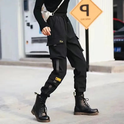 Black cargo pants with multiple pockets and yellow brand patches designed as casual Korean harem loose pants joggers