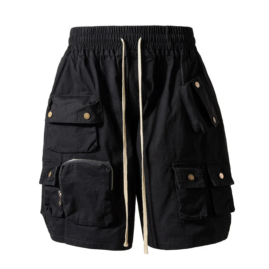 Black cargo shorts with multiple pockets brass-toned buttons and beige drawstring for hip hop y2k streetwear fashion