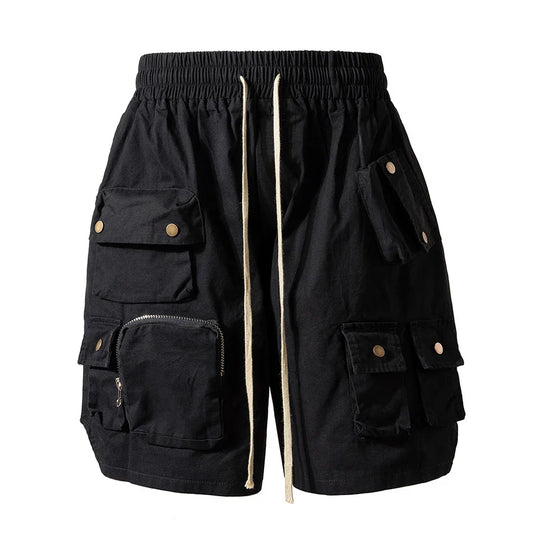 Black cargo shorts with multiple pockets brass-toned buttons and beige drawstring for hip hop y2k streetwear fashion