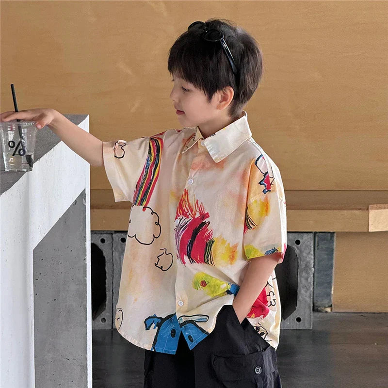 A child wearing a cream short-sleeved hiphop fashion style shirt with vibrant cartoon graphics for dance clothes y2k