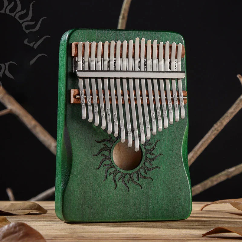 Green wooden hluru kalimba finger piano with silver metal tines and sun-engraved design musical instrument mbira