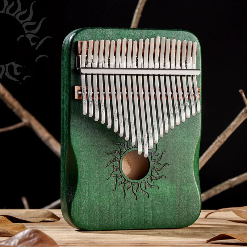 Green wooden kalimba finger piano with silver metal tines and sun motif carved body for beginner music lovers