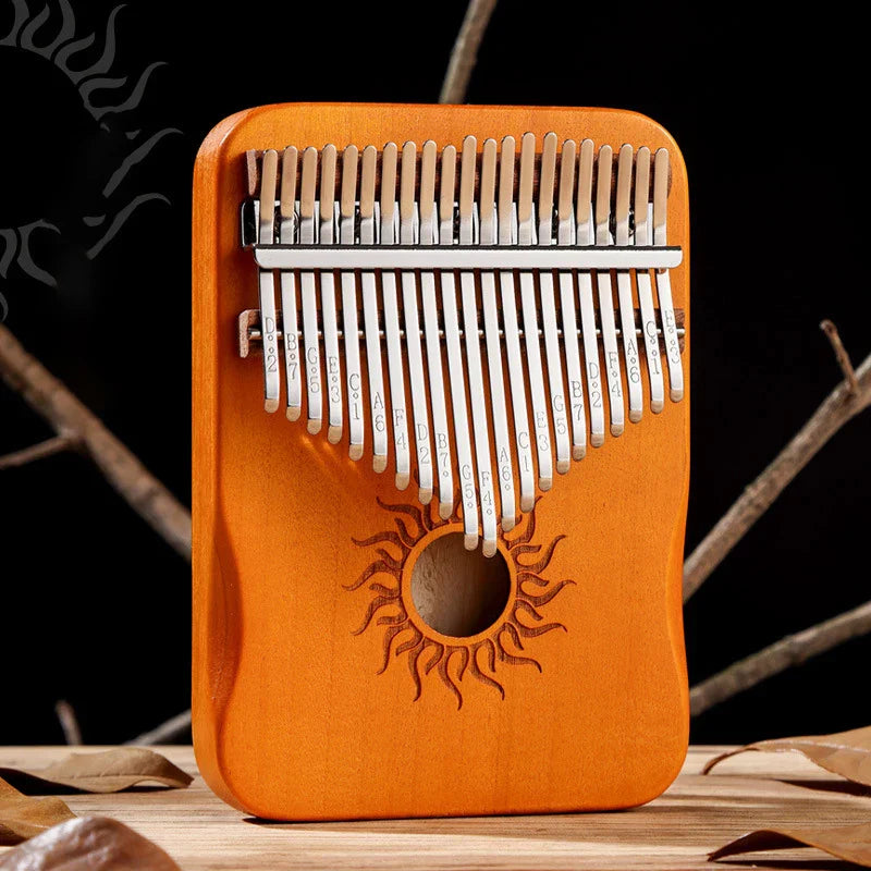 Hluru orange wooden kalimba finger piano with silver metal tines and sun-engraved sound hole musical instrument mbira