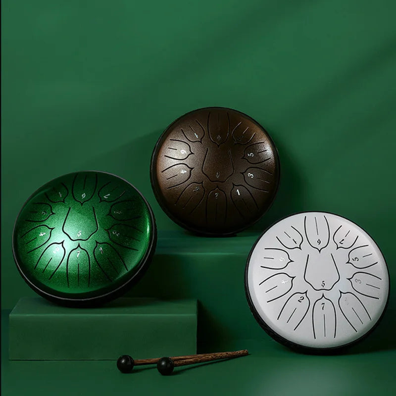 Three handcrafted hluru glucophone steel tongue drums in green bronze and white with engraved notes for yoga meditation percussion