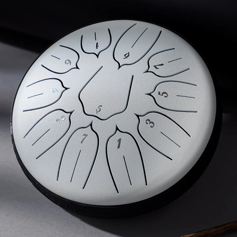 Silver-toned hluru glucophone steel tongue drum with engraved numbers and leaf-shaped chambers for yoga meditation percussion