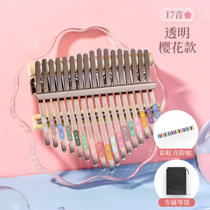 A 17-note transparent sakura-themed crystal acrylic kalimba with metallic keys and rainbow stickers for child keyboard instrument use