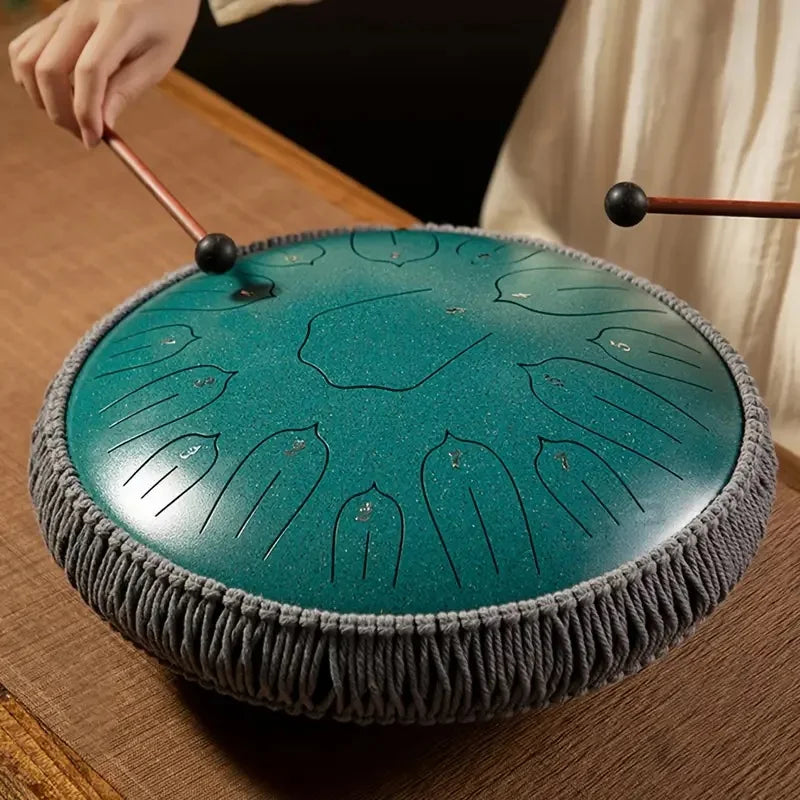 Teal handcrafted steel tongue drum with textured surface and leaf etchings by Hluru music drum tone ethereal drum