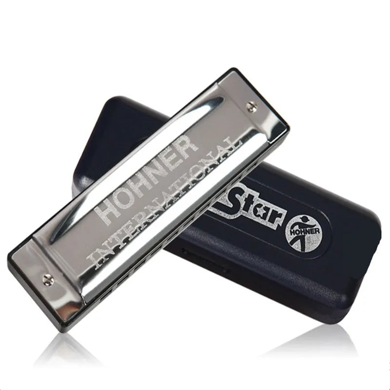 Shiny silver hohner blues harp key mouth organ sliver star gaita harmonica resting on black protective case