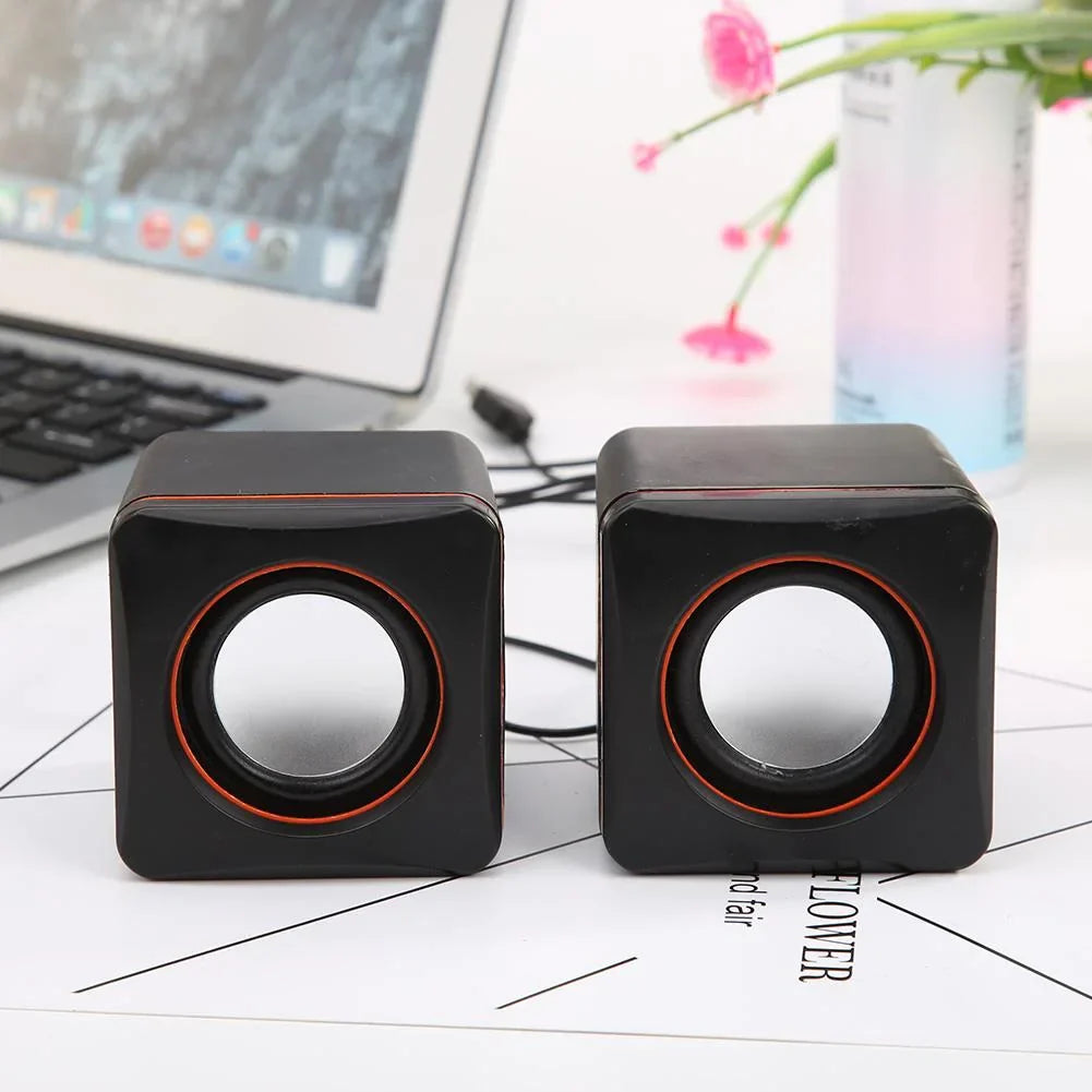 Black cube-shaped home laptop mini usb powered dual stereo speaker system with orange-accented circular drivers