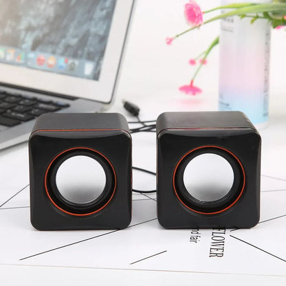 Black cube-shaped home laptop mini usb powered dual stereo speaker system with orange-accented circular drivers