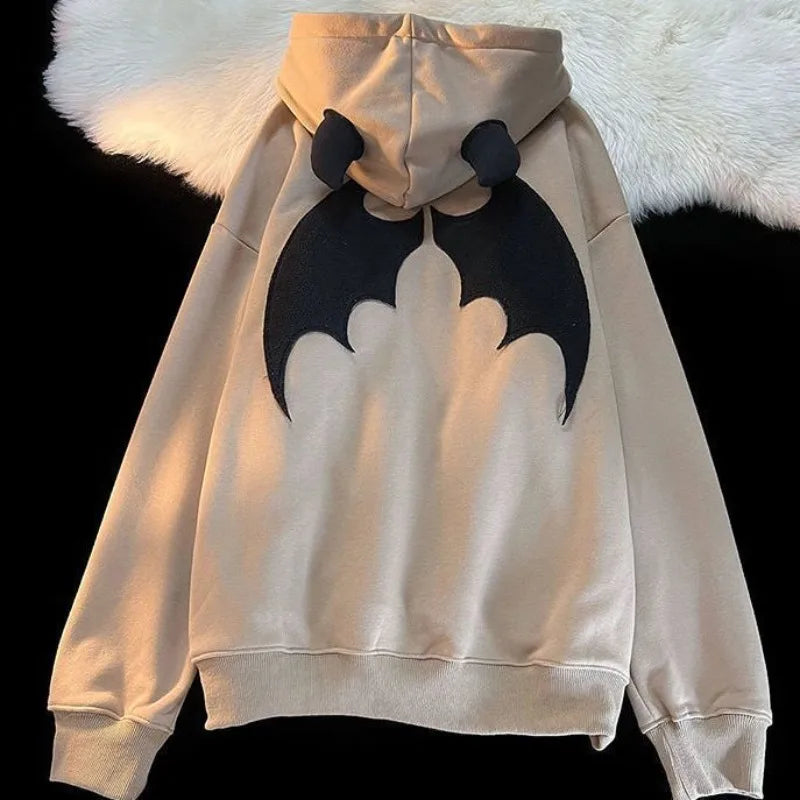 Beige zip up hoodie with black bat design and plush devil horns in vintage harajuku hoody y2k aesthetic grunge style