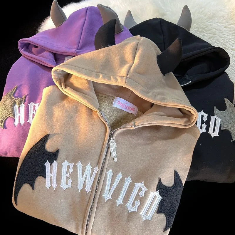 Tan zip-up hoodie with black bat appliqués white gothic lettering and gray horned hood trim vintage harajuku hoody y2k aesthetic grunge