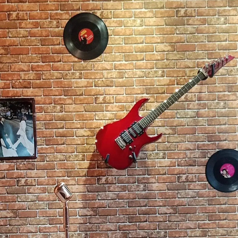 Red electric guitar with glossy finish and black hardware mounted on a horizontal metal guitar wall mount hanger stand