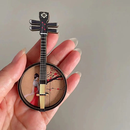 Black and gold miniature banjo pin with traditional chinese woman in red playing a chinese classical instrument courtesan pattern