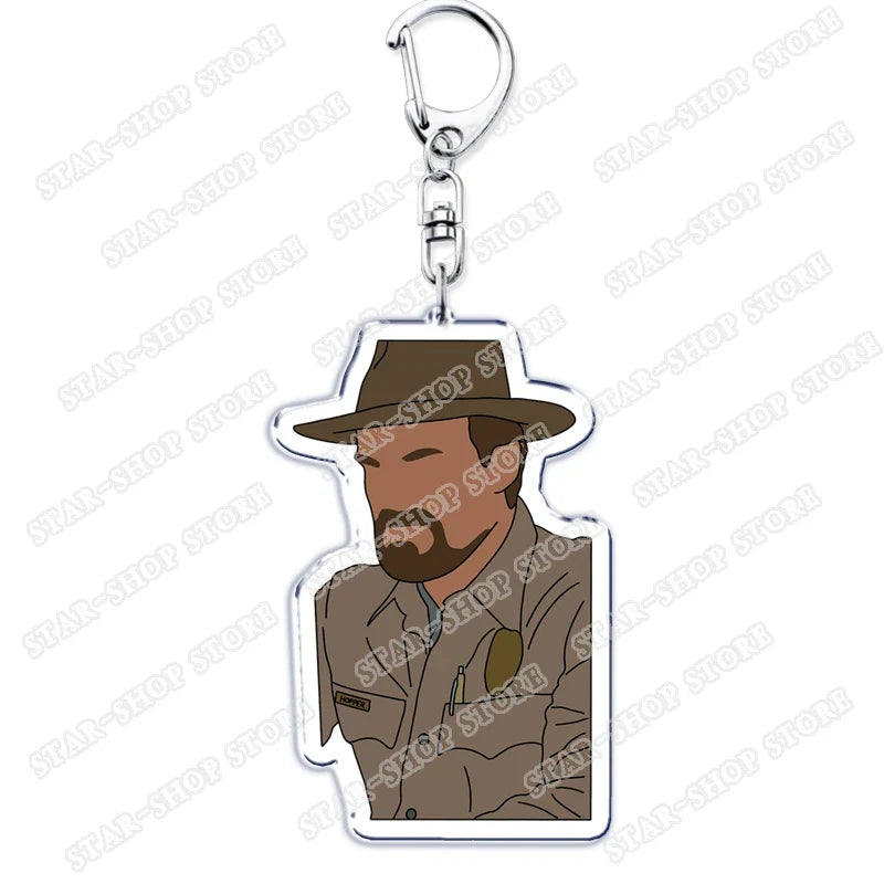 A clear acrylic elements keychain accessory featuring a stylized man in brown hat and uniform for byers eleven mike jewelry fans gifts