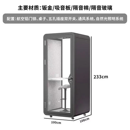 A sleek gray acoustic privacy booth with frosted glass and built-in desk for studio mobile phone and singing room recording