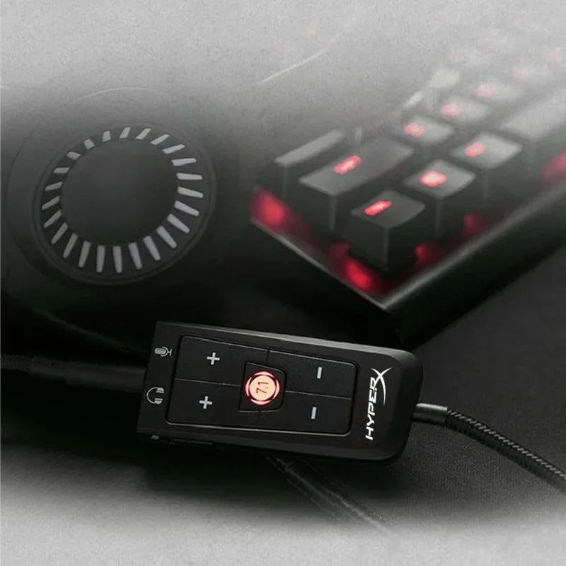 Black hyperx cloud audio control module with red illuminated buttons and circular dial for virtual surround sound card use
