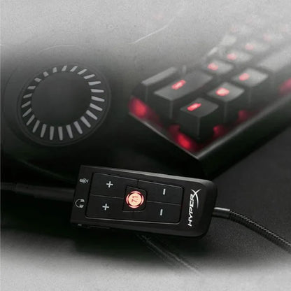 Black hyperx cloud audio control module with red illuminated buttons and circular dial for virtual surround sound card use