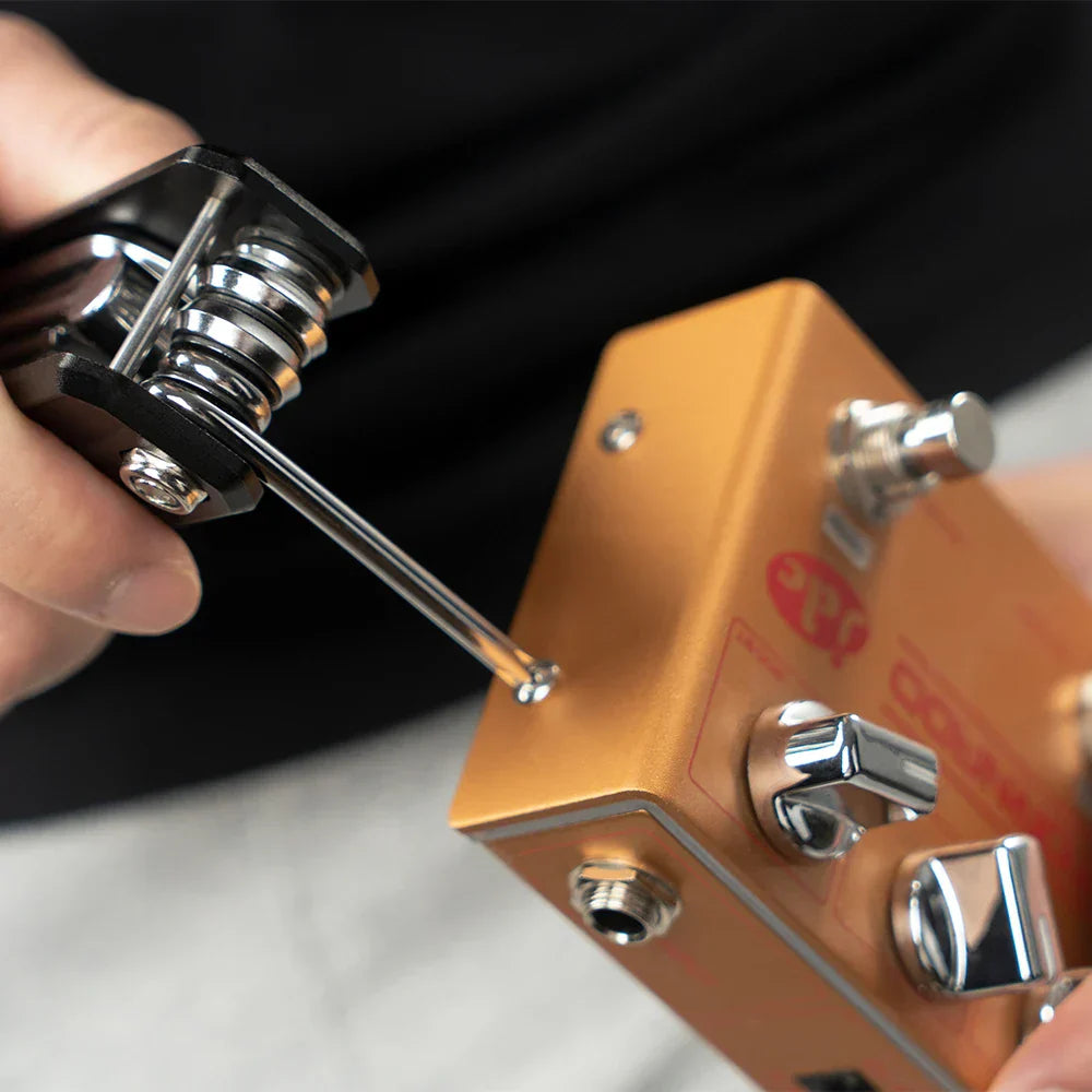 A sleek gold-colored aluminum joyo ggt-01 guitto series guitar repair tool with chrome knobs and red logo multipurpose design