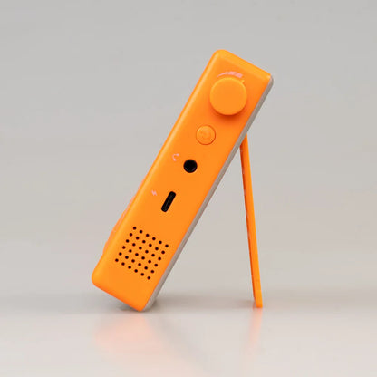 Bright orange JOYO JM-92 electronic metronome with gray accents featuring countdown function and LED screen for guitar and bass