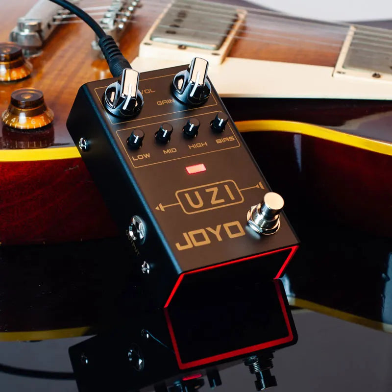 Black joyo uzi distortion electric guitar pedals processor footswitch with gold lettering silver knobs and red led indicator