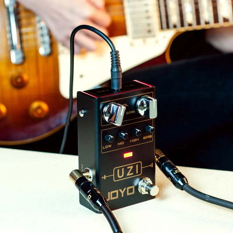 Black rectangular uzi distortion electric guitar pedals processor footswitch with silver knobs and gold lettering for music true bypass