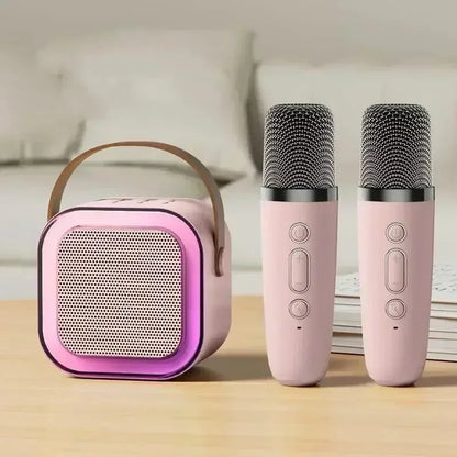 Pink and purple k12 bluetooth portable speaker with leather handle and two matching pink karaoke microphones for family singing