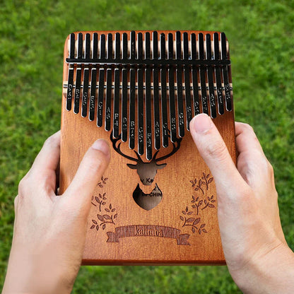 A professional thumb piano wooden kalimba with 21 black metal tines engraved deer head and brand name includes instruction carrying bag