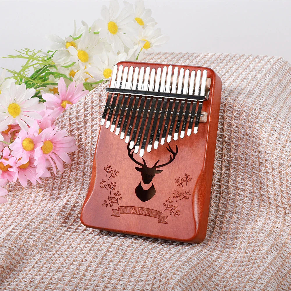 Reddish-brown wooden kalimba finger piano with carved deer head and black metal tines musical instrument mbira