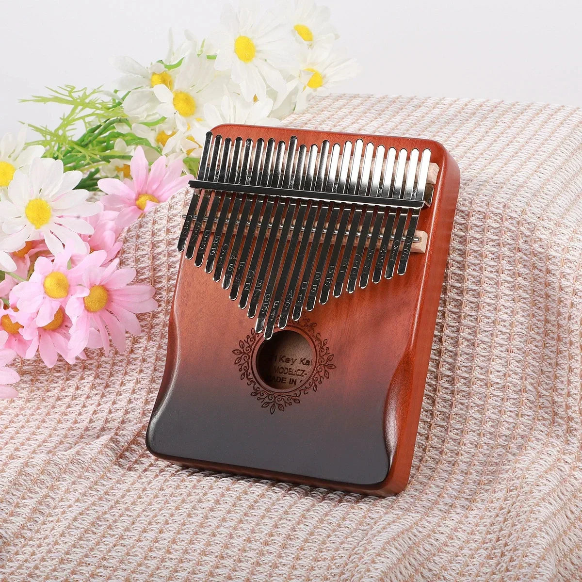 A polished wooden kalimba finger piano with 17 silver tines and engraved design musical instrument mbira for beginners